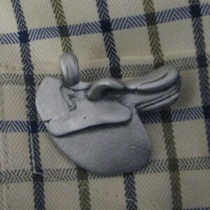 Side saddle pewter pin brooch
